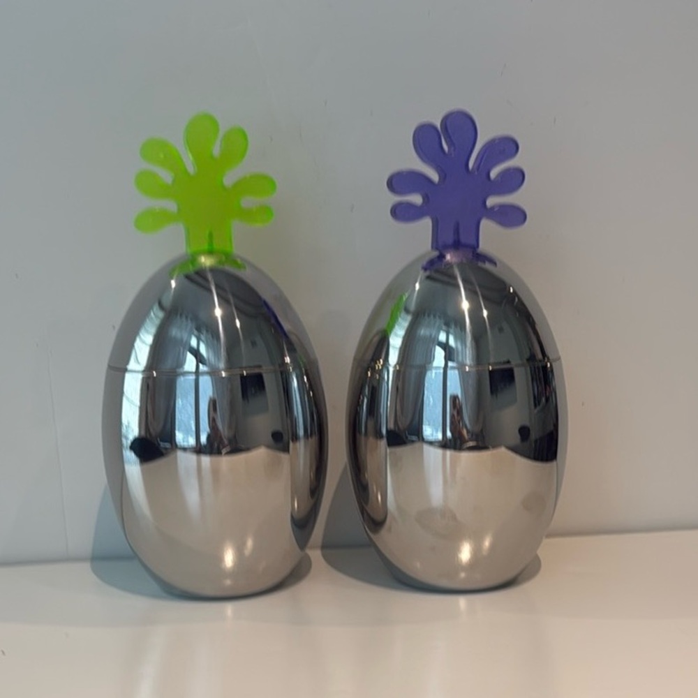 Alessi kitchen stainless steel storage containers egg shaped with colorful top.